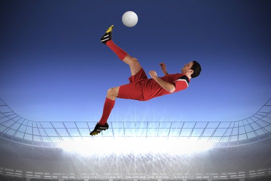 Football player in red kicking