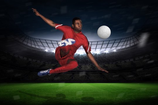 Football player in red kicking