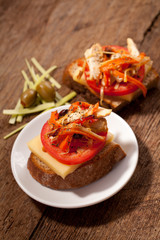 Wall Mural - Sandwich with tomato on a table with meat, tomato and olives