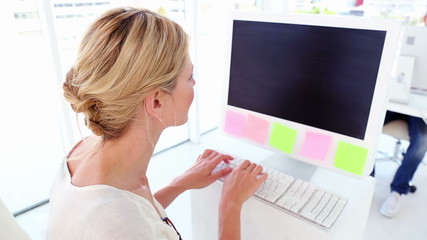 Wall Mural - Happy businesswoman working at her desk