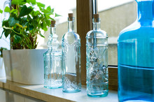 Decorative Bottles From Blue Glass On A Windowsill