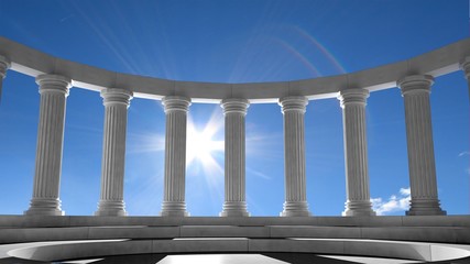 Ancient marble pillars in elliptical arrangement with blue sky