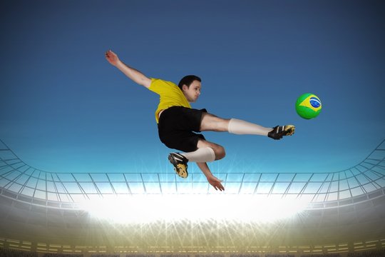 Football player in yellow kicking