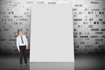 Poster - Composite image of businessman looking up