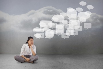 Poster - Composite image of businesswoman sitting cross legged thinking