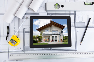 Poster - Digital Tablet With Architect's Tools Over Blueprint