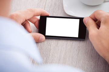 Businessman's Hand Holding Smartphone With Blank Screen