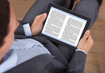 Poster - Businessman Reading eBook In Office