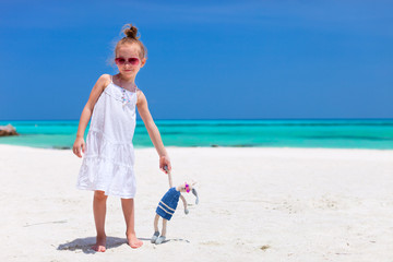 Poster - Little girl with toy at beach