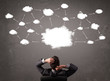 Businessman sitting with cloud technology above his head