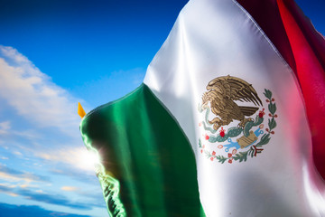 Mexican flag against a bright sky, independence day, cinco de ma