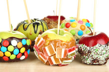 Candied Apples On Sticks On Wooden Table Close Up