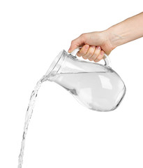 Wall Mural - Pouring water from glass pitcher, isolated on white