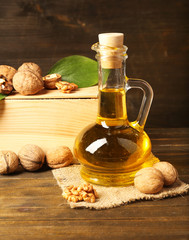 Poster - Walnut oil and nuts on wooden table