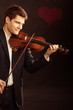 © Voyagerix - Man violinist playing violin. Classical music art