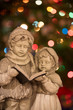 Statue of Boy and Girl Carolers with Christmas Lights