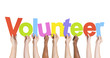 © Rawpixel.com - Diverse Hands Holding The Word Volunteer