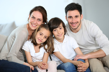 Wall Mural - Happy family sitting together in couch