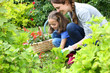 © goodluz - Little girl helping her mother to do gardening