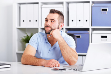 Wall Mural - Image of pensive young businessman with notebook looking up