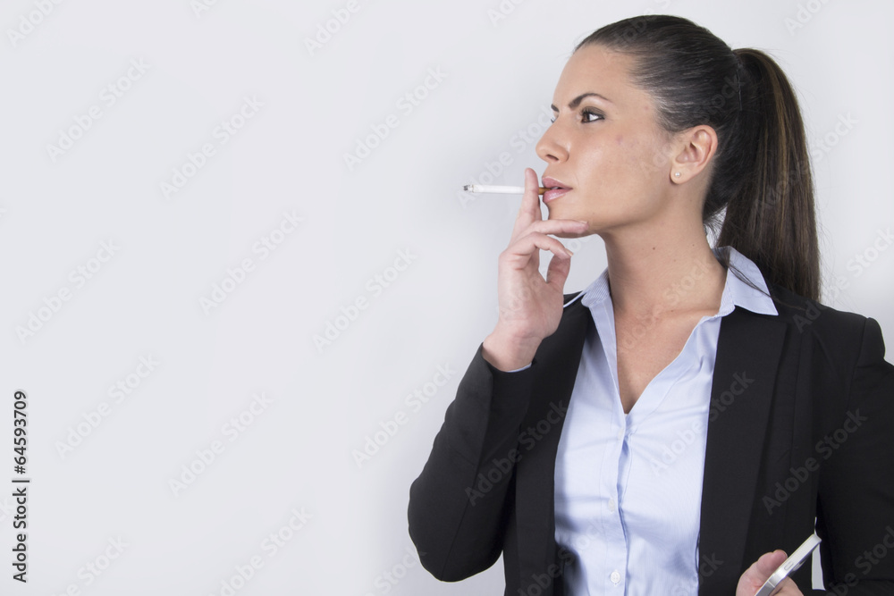 beautiful business woman smoking a cigarette Stock Photo