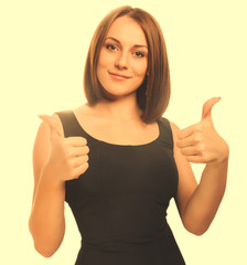 happy young woman girl a shows positive studio sign thumbs yes,