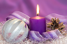 Christmas Ball With Burning Candle And Gift Ribbon In Lilac Tone