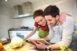 © goodluz - Couple at home looking for recipe on internet