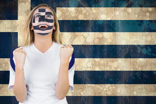 Excited greece fan in face paint cheering