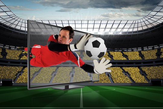 Fit goal keeper saving goal through tv
