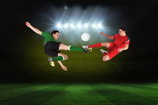 Football players tackling for the ball