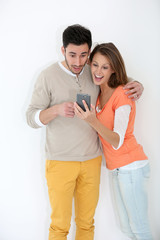 Wall Mural - Couple reading text message on smartphone