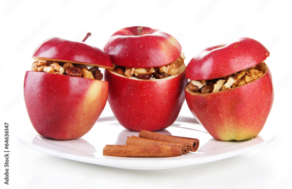 Apples with raisins and nuts on plate isolated on white