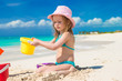 © travnikovstudio - Adorable little girl playing with toys on beach vacation