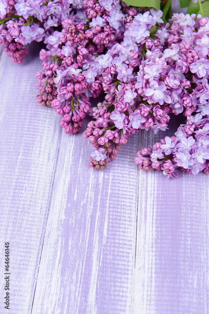 Beautiful lilac flowers on wooden background