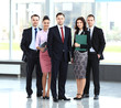 © opolja - Group portrait of professional business team looking confidently