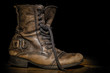 Old boot on the dark background.