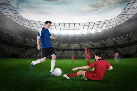 Football player in blue kicking