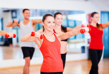 Sticker - group of smiling people working out with dumbbells