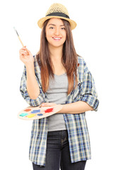 Poster - Beautiful female artist holding a paintbrush