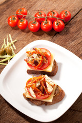 Wall Mural - bread seasoned with oil and sliced tomatoes on a table