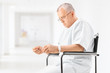 Worried mature patient sitting in a hospital corridor