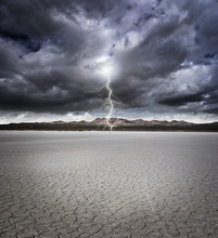 Dry Lake Bed With Storm Clouds And Lightning