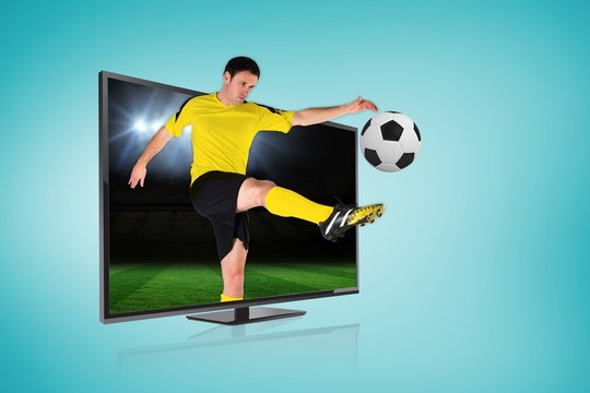 Football player kicking ball through tv