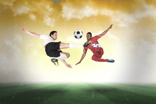 Football players tackling for the ball