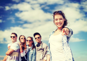 Wall Mural - teenage girl with headphones and friends outside