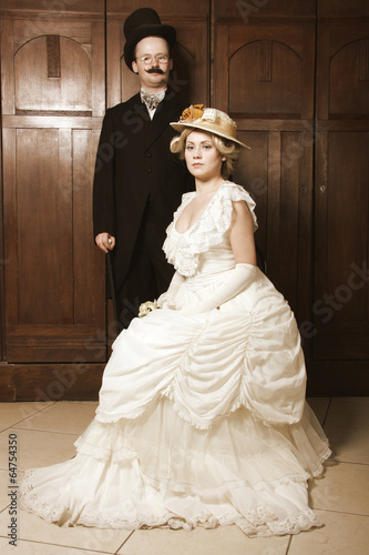Couple in 19th century garment with woman in dominant role Poster