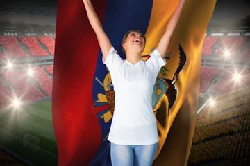 Wall Mural - Pretty football fan in white cheering holding ecuador flag