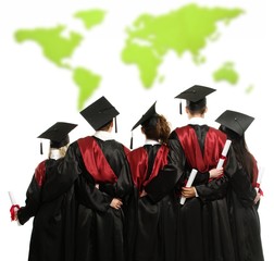 Group of graduated young students in black mantles 