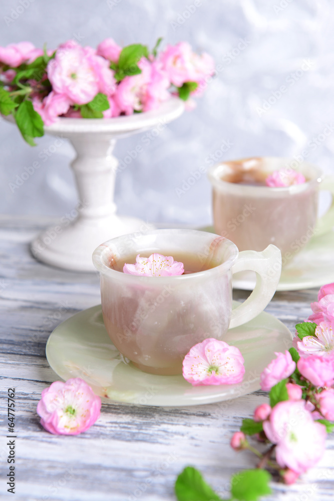 Beautiful fruit blossom with cup of tea